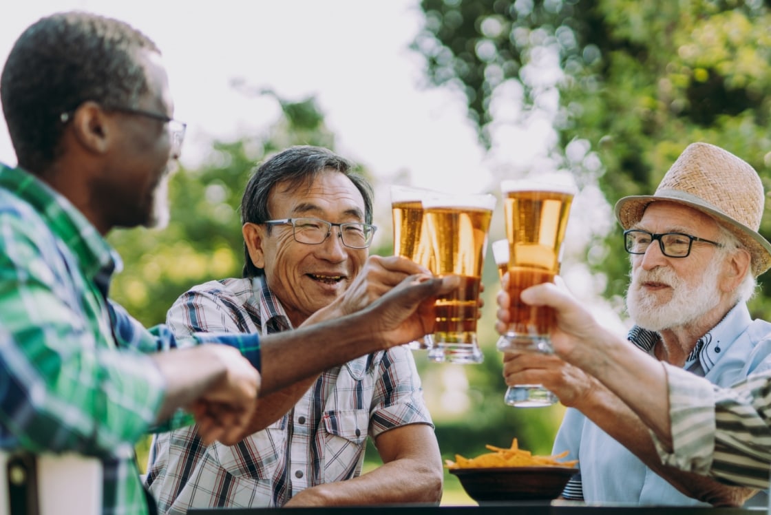 4 men doing a cheers with beers.